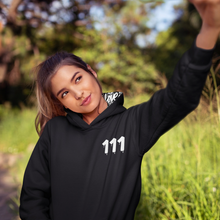 Load image into Gallery viewer, Black hoodie with 111 Angel Number design from Angel Numbers Merch Official, symbolizing new beginnings & manifestation.