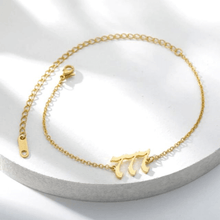 Load image into Gallery viewer,  Gold 777 Angel Number Ankle Bracelet from Angel Numbers Merch Official, representing intuition, divine knowledge, and alignment.

